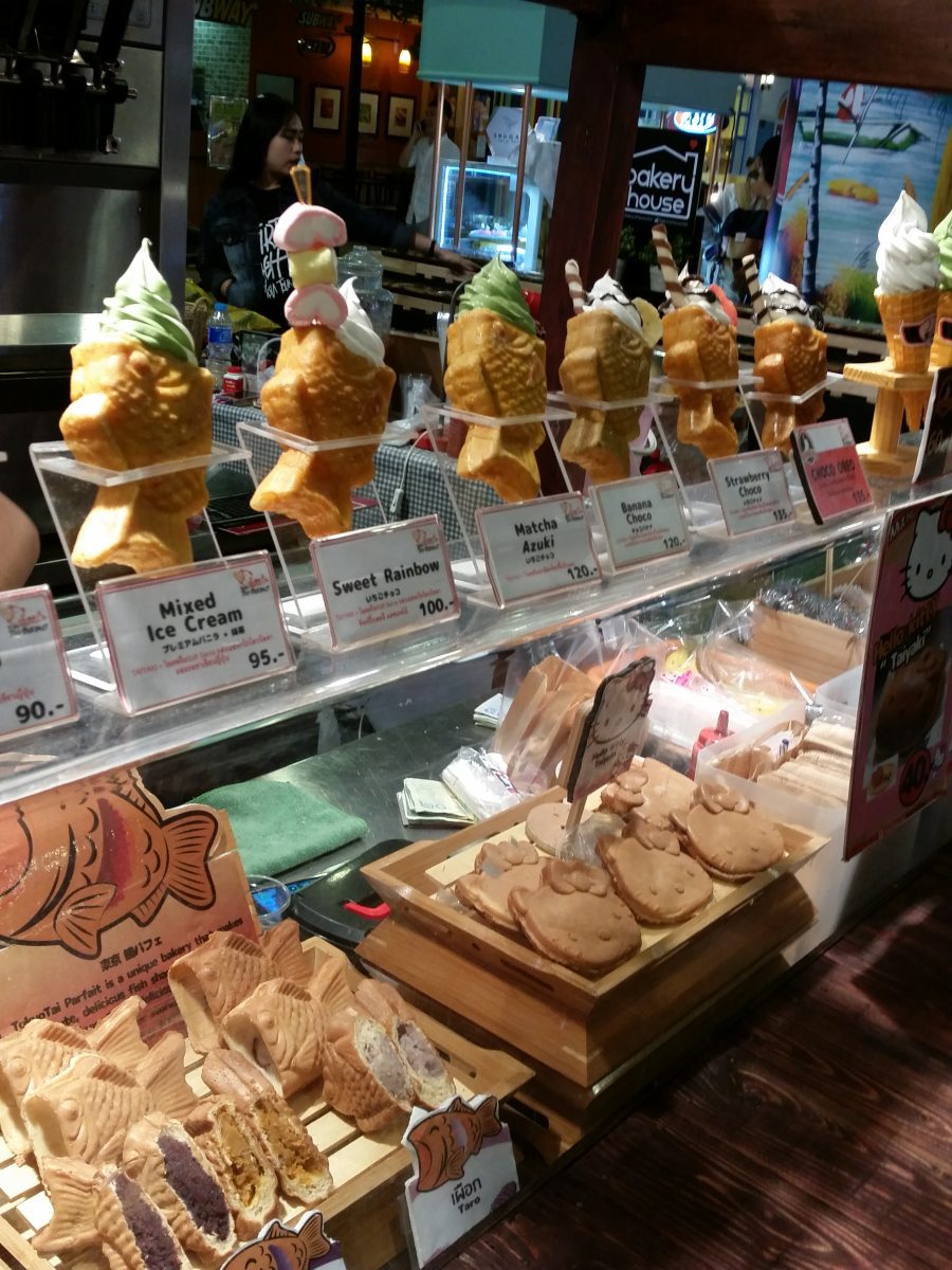 Taiyaki fish-shaped ice cream cone filled with soft serve ice cream