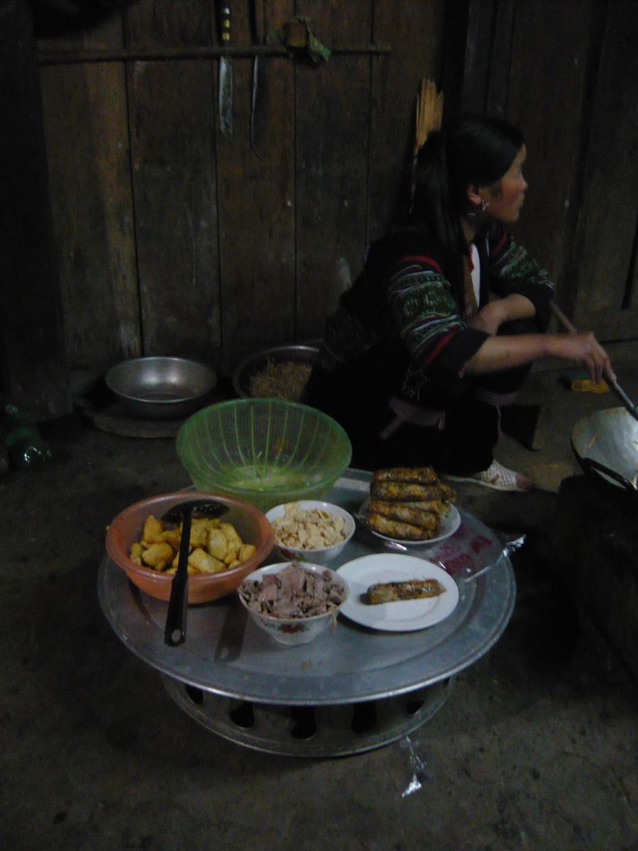 Our Hmong guide helping our host with the preparation of food